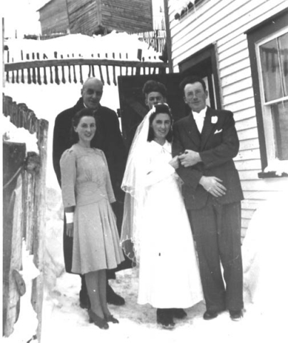 076: l-r back, Fr. Fyme, Alec Ryan; front, maid of honour Theresa Ryan, Anne Ryan, and Anne's husband  Alfred Grant, standing by the Ryan house. (1943) [courtesy of Mollie McCarthy]  - Alec is the son of Michael Ryan &amp;amp; Petronella Whelan; Marie and Anne are the daughters of  Joseph Ryan &amp;amp; Ursula Barry
2024-03-24 Correction submitted by Gary M. Grant, 4th son of Alfred &amp;amp; Annie, properly identifying Theresa, not Marie, as the maid of honour.